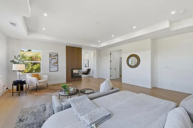 a living room with couches a coffee table and couch with wooden floor