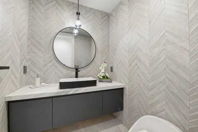 a bathroom with a sink mirror and vanity