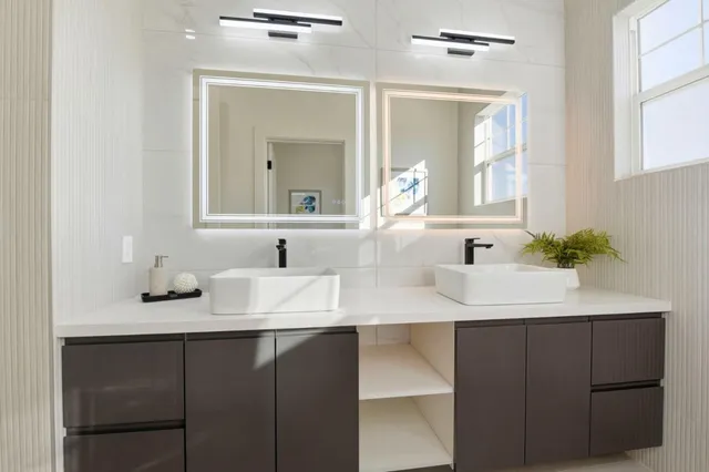 a bathroom with a sink vanity and a mirror