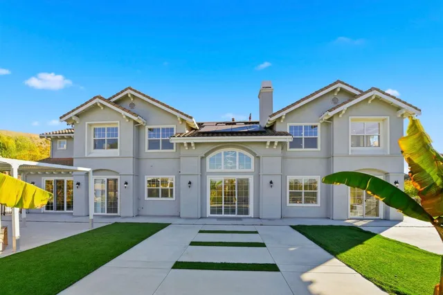 an aerial view of a house with a yard