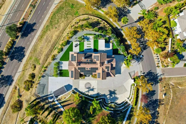 a aerial view of a house with a yard balcony and outdoor seating