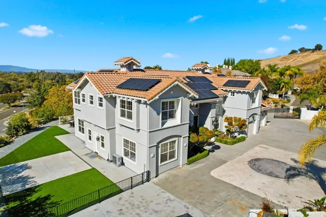 a aerial view of a house with a big yard and large trees