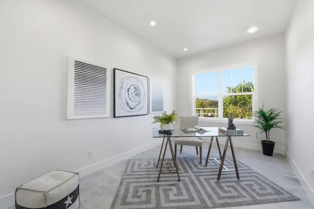 a workspace with furniture and a potted plant