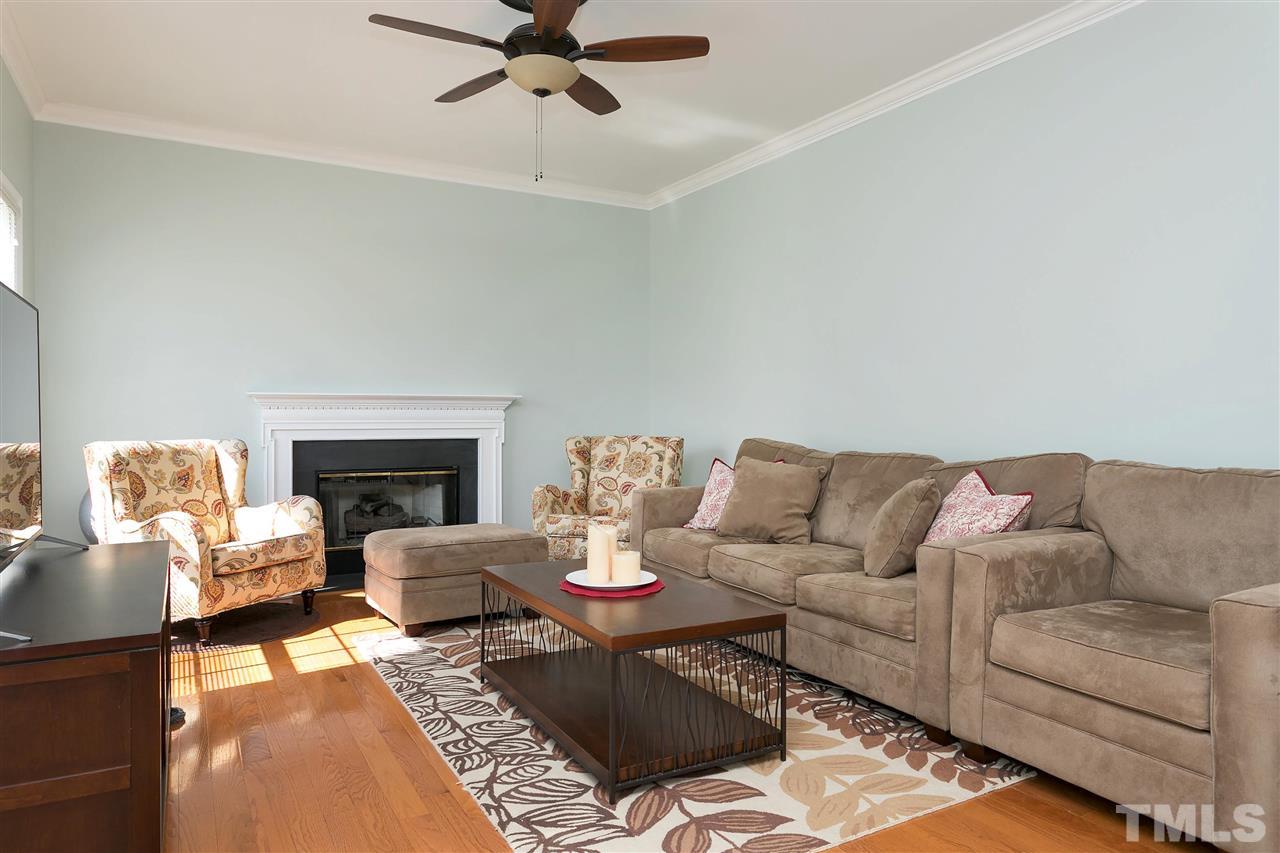2337 Bolingbrook Lane Raleigh, NC 27613 - Photo 11 of 25 a living room with furniture and a fireplace