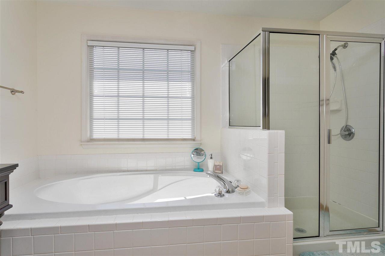 2337 Bolingbrook Lane Raleigh, NC 27613 - Photo 16 of 25 a bathroom with a bathtub and a shower