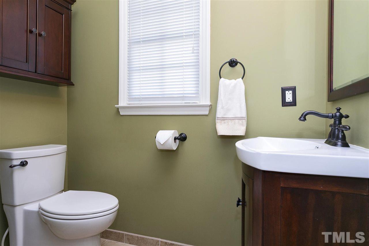 2337 Bolingbrook Lane Raleigh, NC 27613 - Photo 19 of 25 a bathroom with a sink a toilet and mirror
