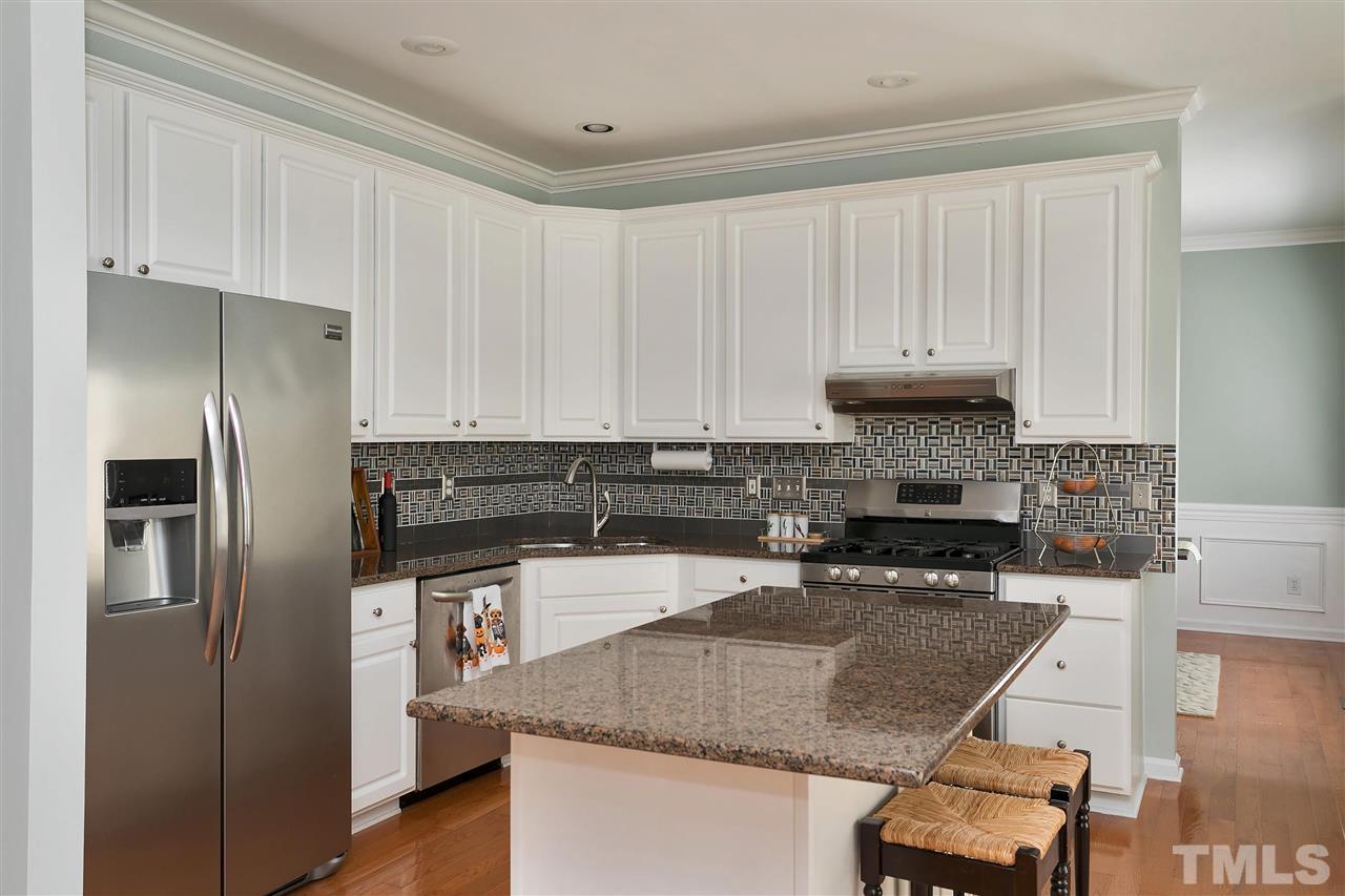 2337 Bolingbrook Lane Raleigh, NC 27613 - Photo 5 of 25 a kitchen with stainless steel appliances granite countertop a refrigerator a stove a sink and white cabinets