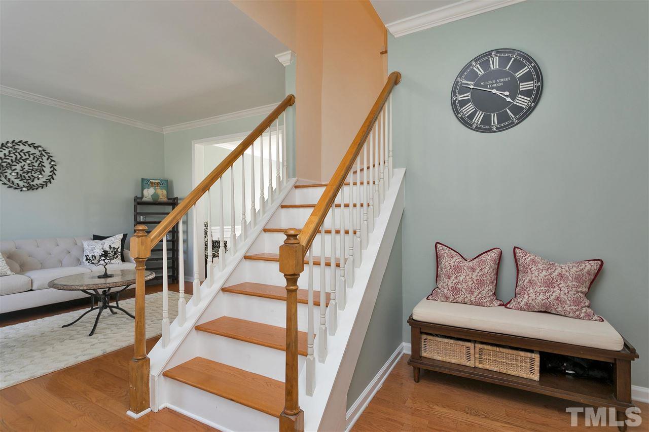 2337 Bolingbrook Lane Raleigh, NC 27613 - Photo 8 of 25 a view of staircase with lots of frames and a rug