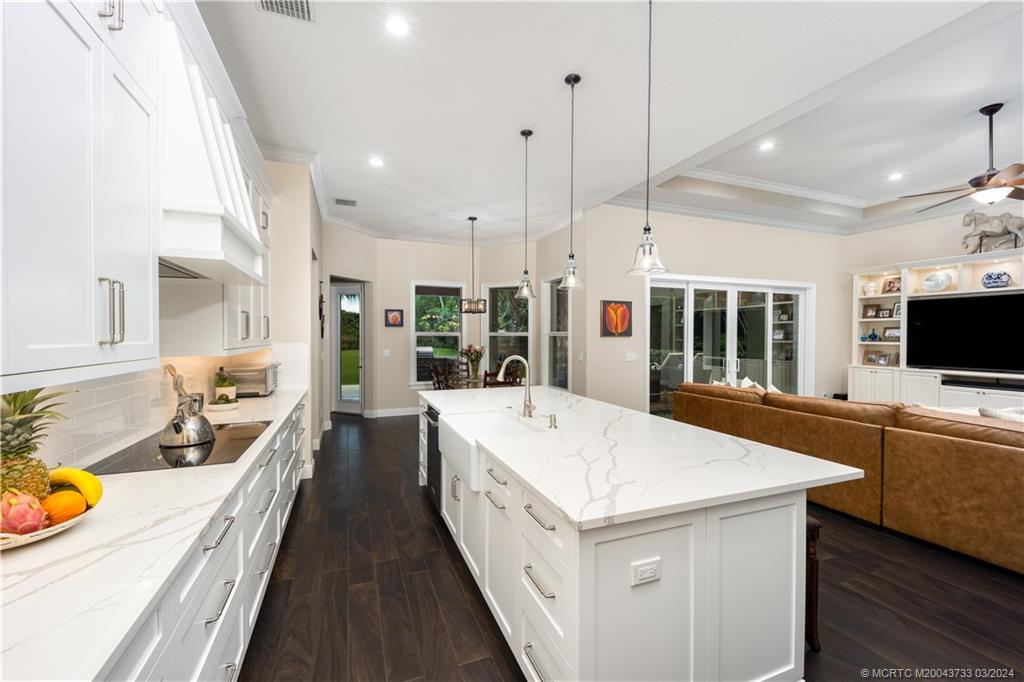1665 Northwest Fork Road Stuart, FL 34994 - Photo 18 of 52 a large white kitchen with a large window and stainless steel appliances