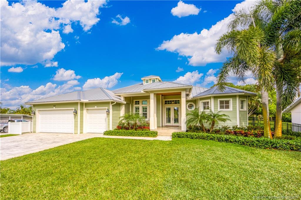 1665 Northwest Fork Road Stuart, FL 34994 - Photo 2 of 52 a front view of a house with a garden
