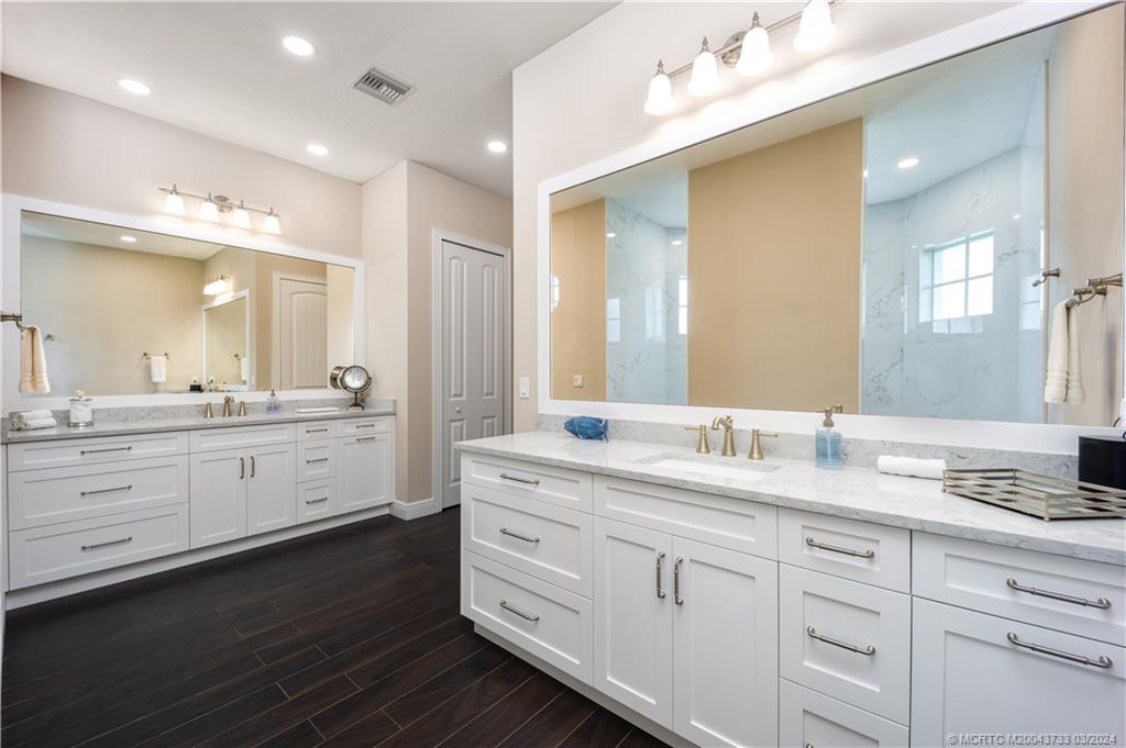 1665 Northwest Fork Road Stuart, FL 34994 - Photo 25 of 52 a bathroom with a granite countertop double vanity sink mirror and