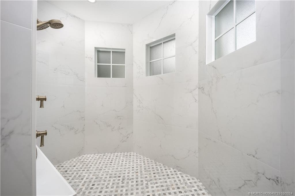 1665 Northwest Fork Road Stuart, FL 34994 - Photo 26 of 52 a bathroom with a shower