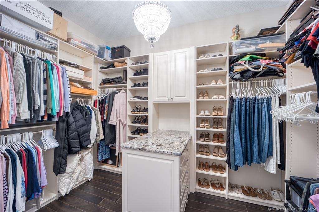 1665 Northwest Fork Road Stuart, FL 34994 - Photo 30 of 52 a view of walk in closet with clothes and shoes
