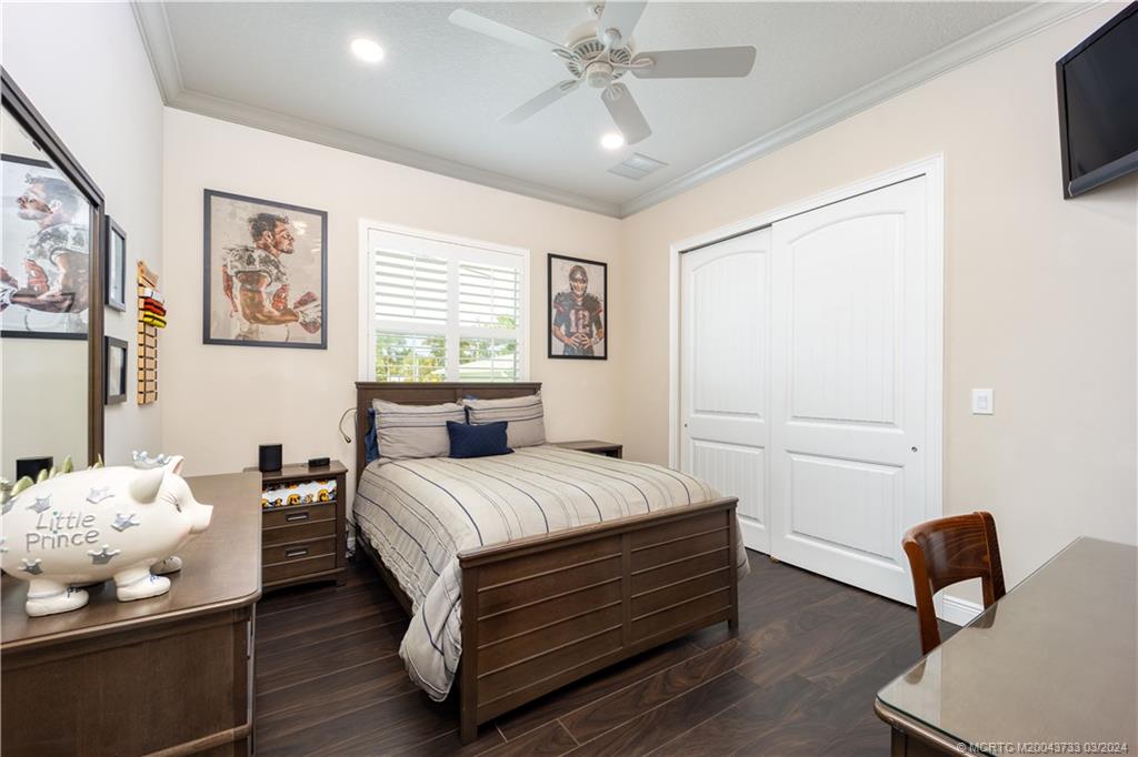 1665 Northwest Fork Road Stuart, FL 34994 - Photo 32 of 52 a bedroom with a bed and wooden floor