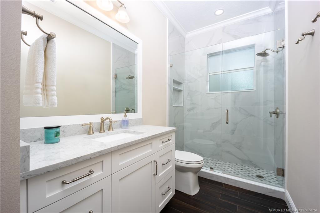 1665 Northwest Fork Road Stuart, FL 34994 - Photo 34 of 52 a bathroom with a sink a toilet and shower