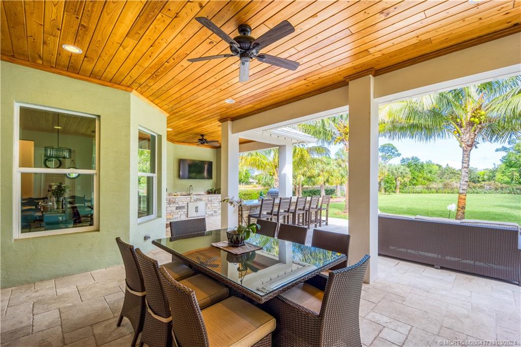 1665 Northwest Fork Road Stuart, FL 34994 - Photo 38 of 52 a view of an outdoor dining space with a table and chairs