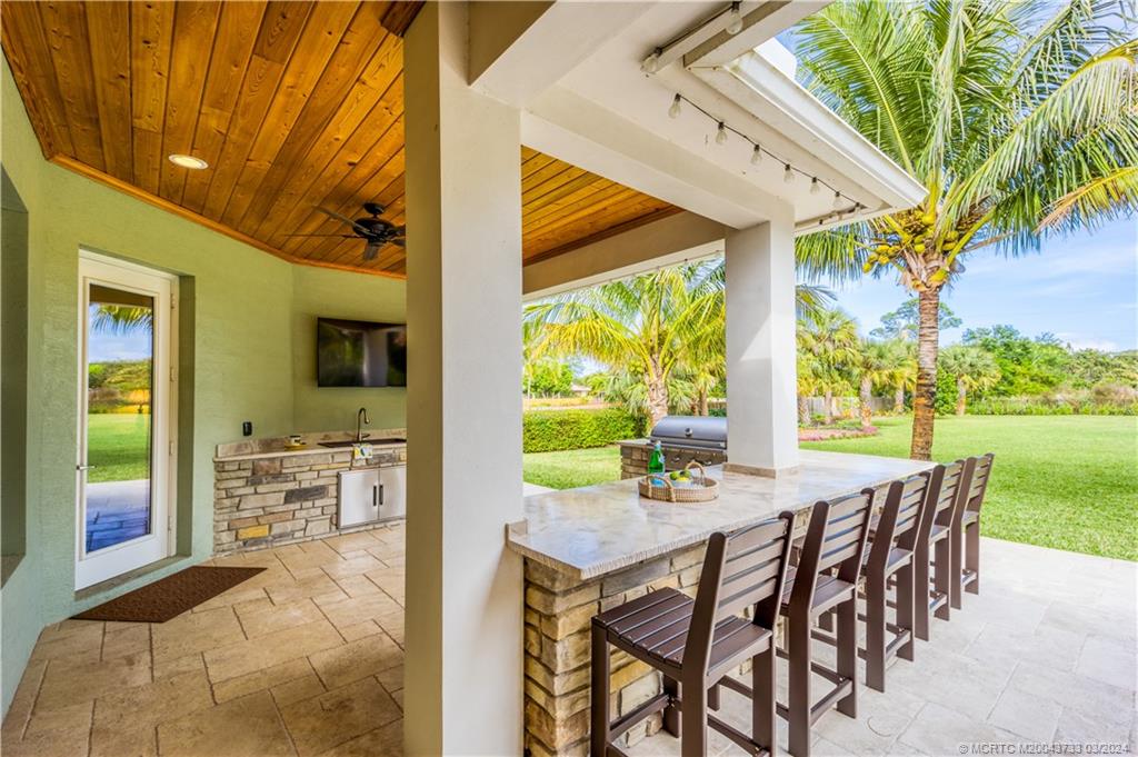 1665 Northwest Fork Road Stuart, FL 34994 - Photo 39 of 52 a view of a patio with a table chairs and backyard