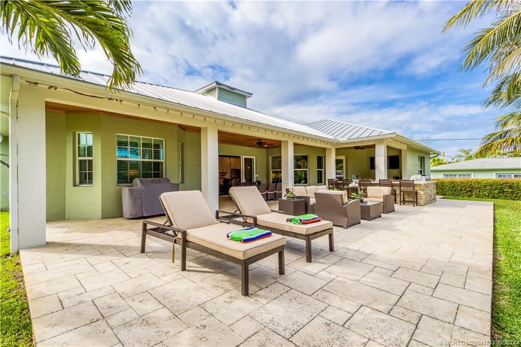 1665 Northwest Fork Road Stuart, FL 34994 - Photo 46 of 52 a building outdoor space with patio furniture and potted plants