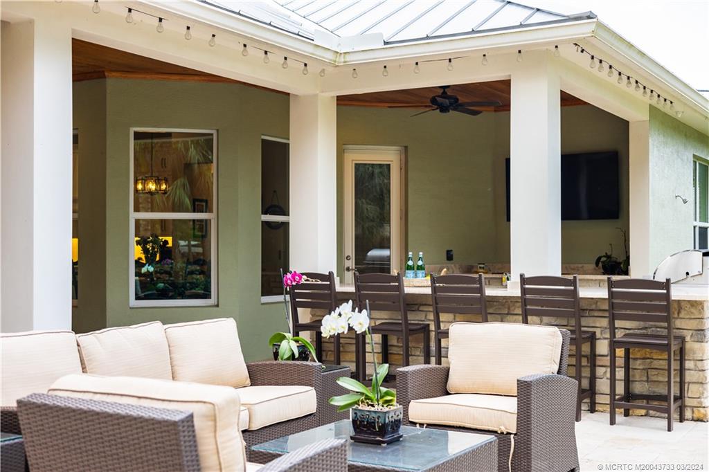 1665 Northwest Fork Road Stuart, FL 34994 - Photo 48 of 52 a outdoor living space with patio furniture and a potted plant