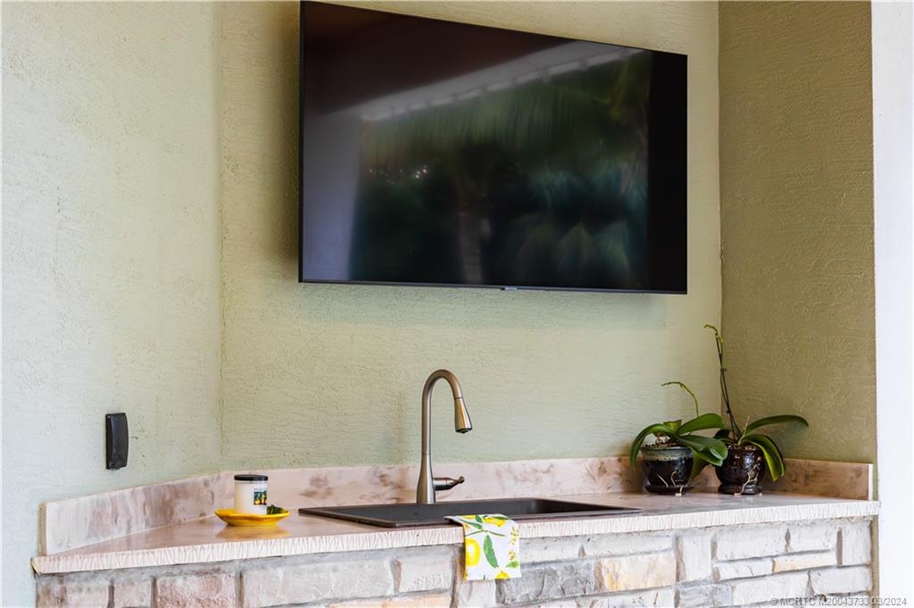 1665 Northwest Fork Road Stuart, FL 34994 - Photo 50 of 52 a bathroom with a sink and a potted plant