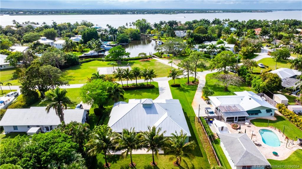1665 Northwest Fork Road Stuart, FL 34994 - Photo 6 of 52 an aerial view of a house with a yard and lake view