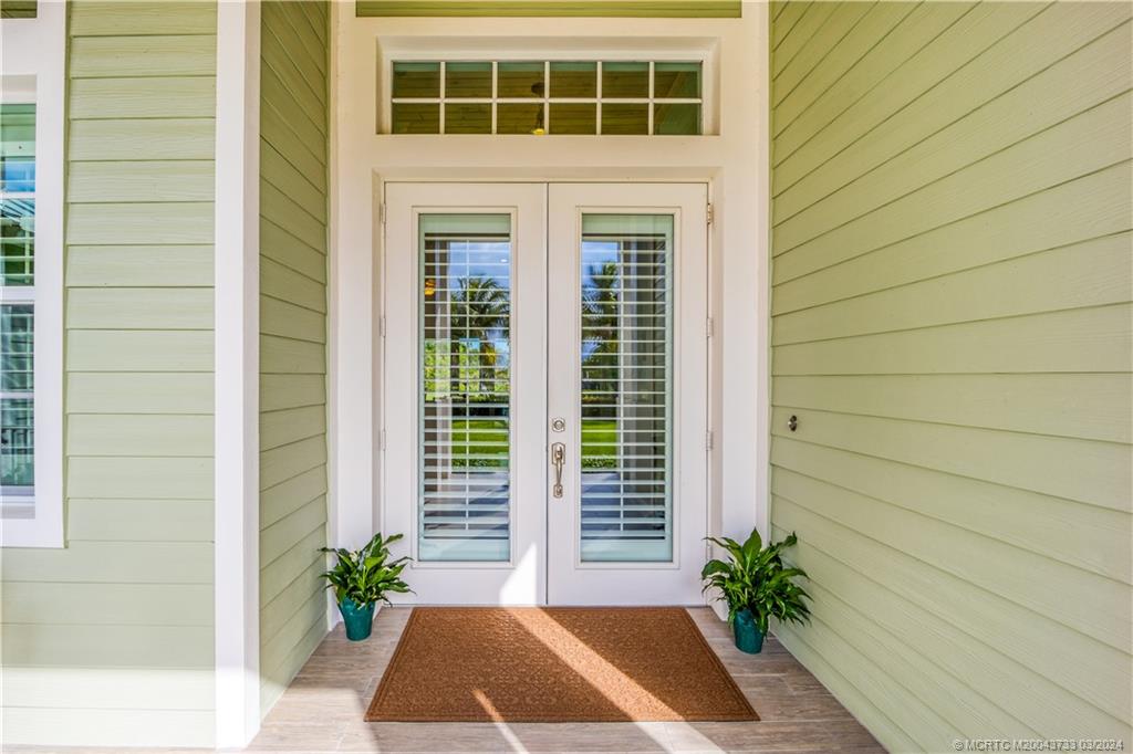 1665 Northwest Fork Road Stuart, FL 34994 - Photo 9 of 52 a view of front door and potted plant