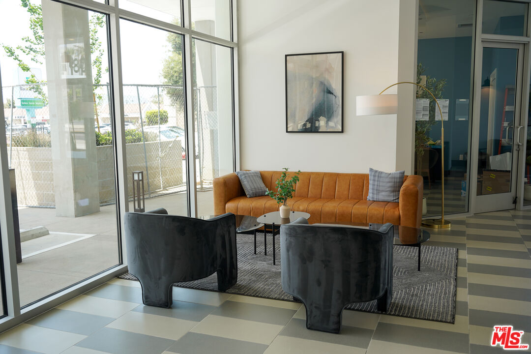 800 Western Avenue, Unit 727 Los Angeles, CA 90005 - Photo 4 of 26 a view of hallway with couch and a potted plant on a table