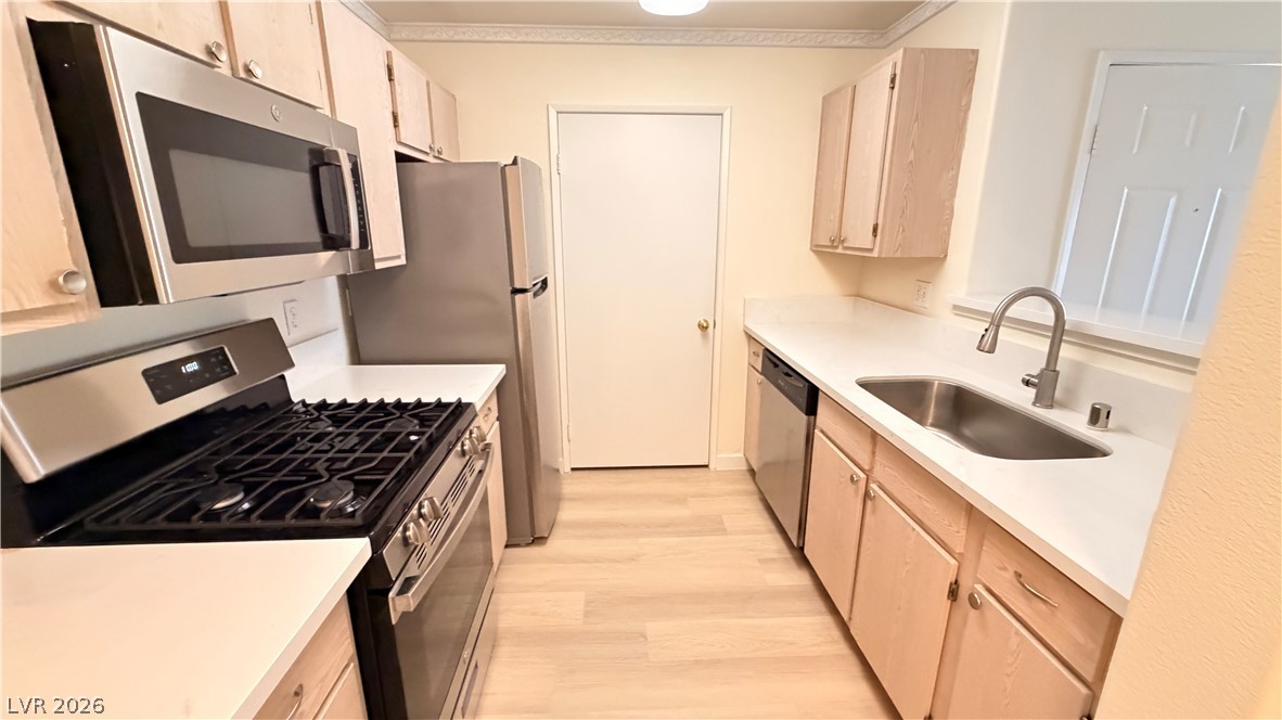 7885 West Flamingo Road, Unit 1131 Las Vegas, NV 89147 - Photo 17 of 36 Well-appointed kitchen features stainless steel appliances and light wood cabinetry with ample counter space.