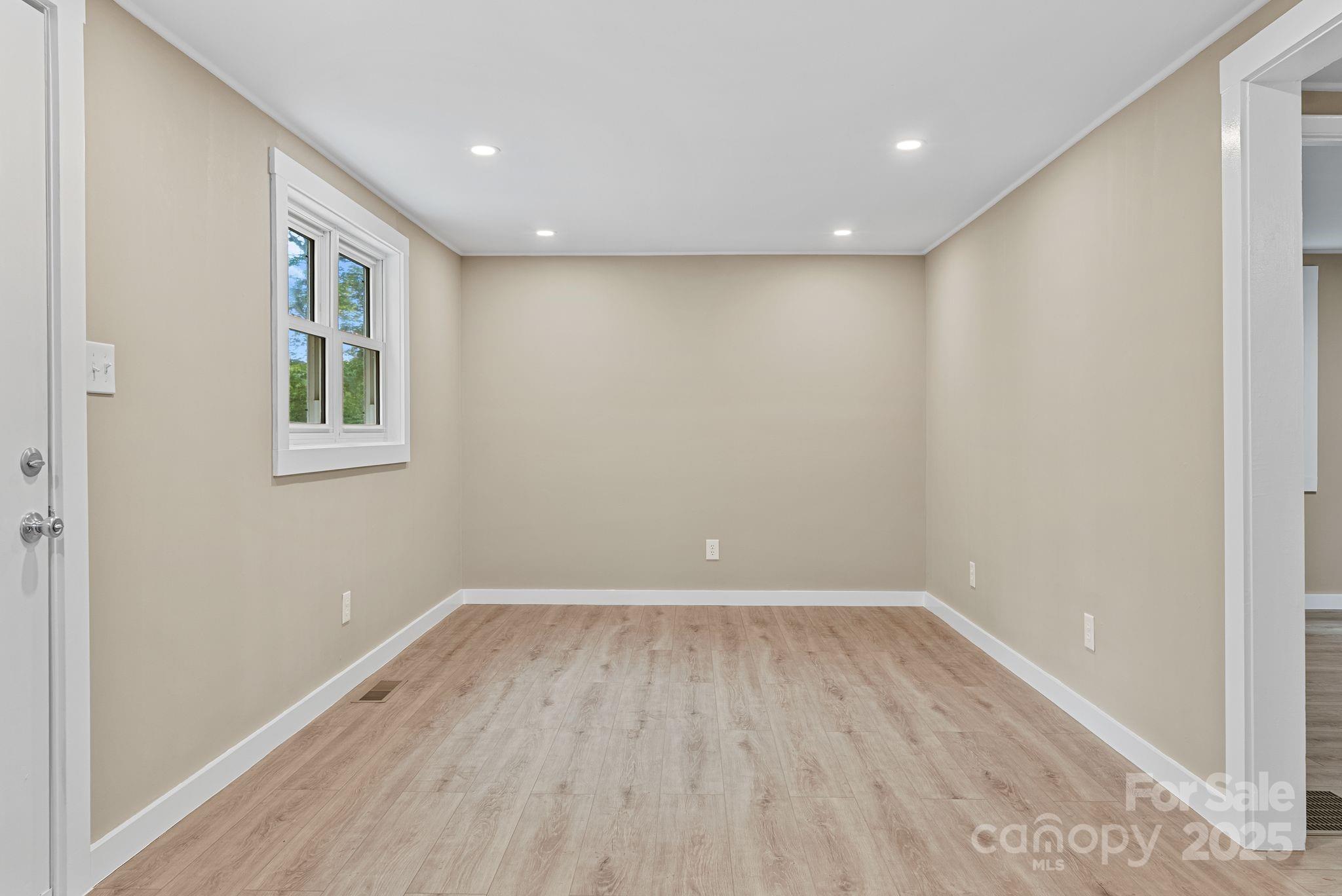 530 Rebel Ridge Road Marshall, NC 28753 - Photo 11 of 46 a view of room with window and wooden floor