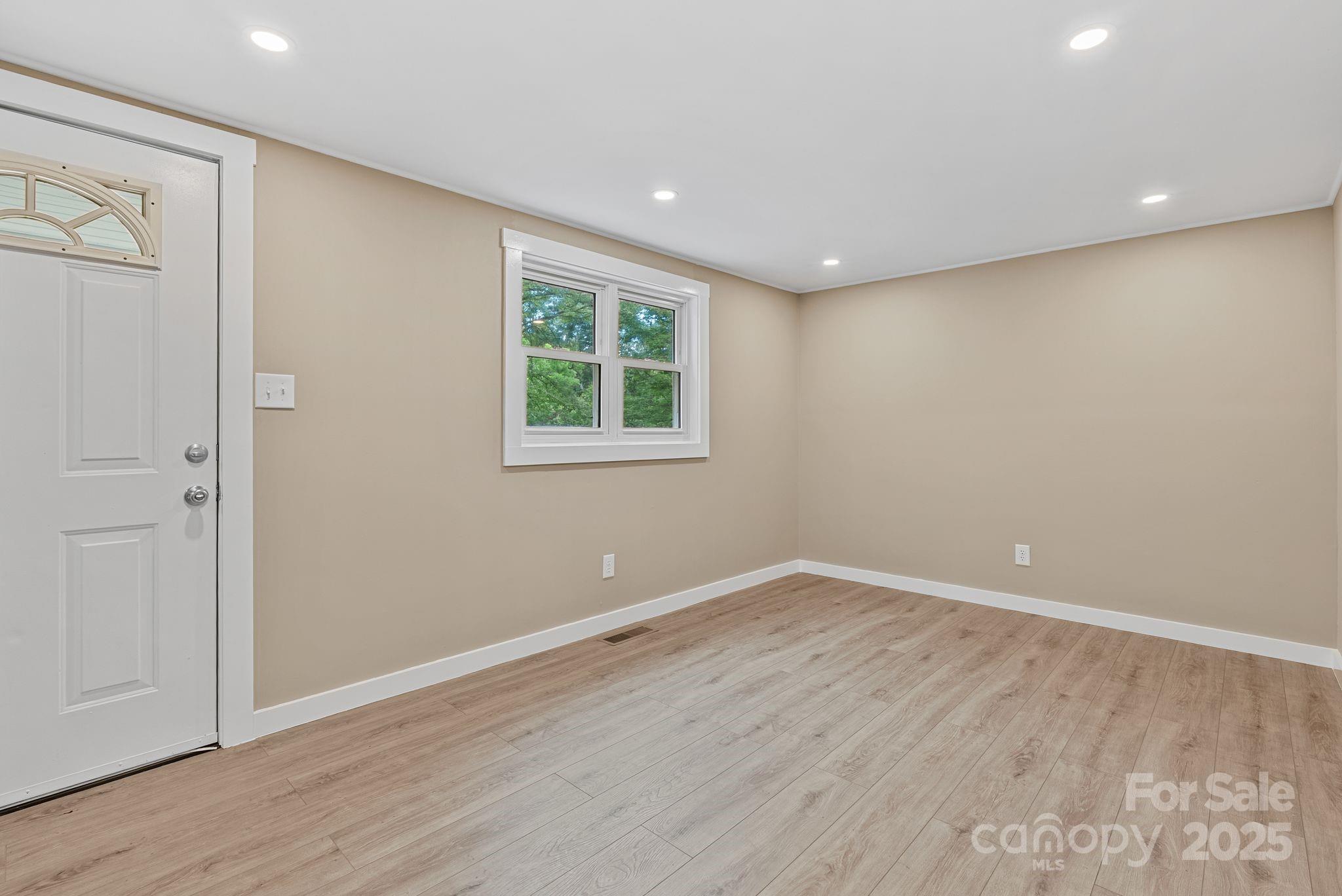 530 Rebel Ridge Road Marshall, NC 28753 - Photo 12 of 46 wooden floor in an empty room with a window
