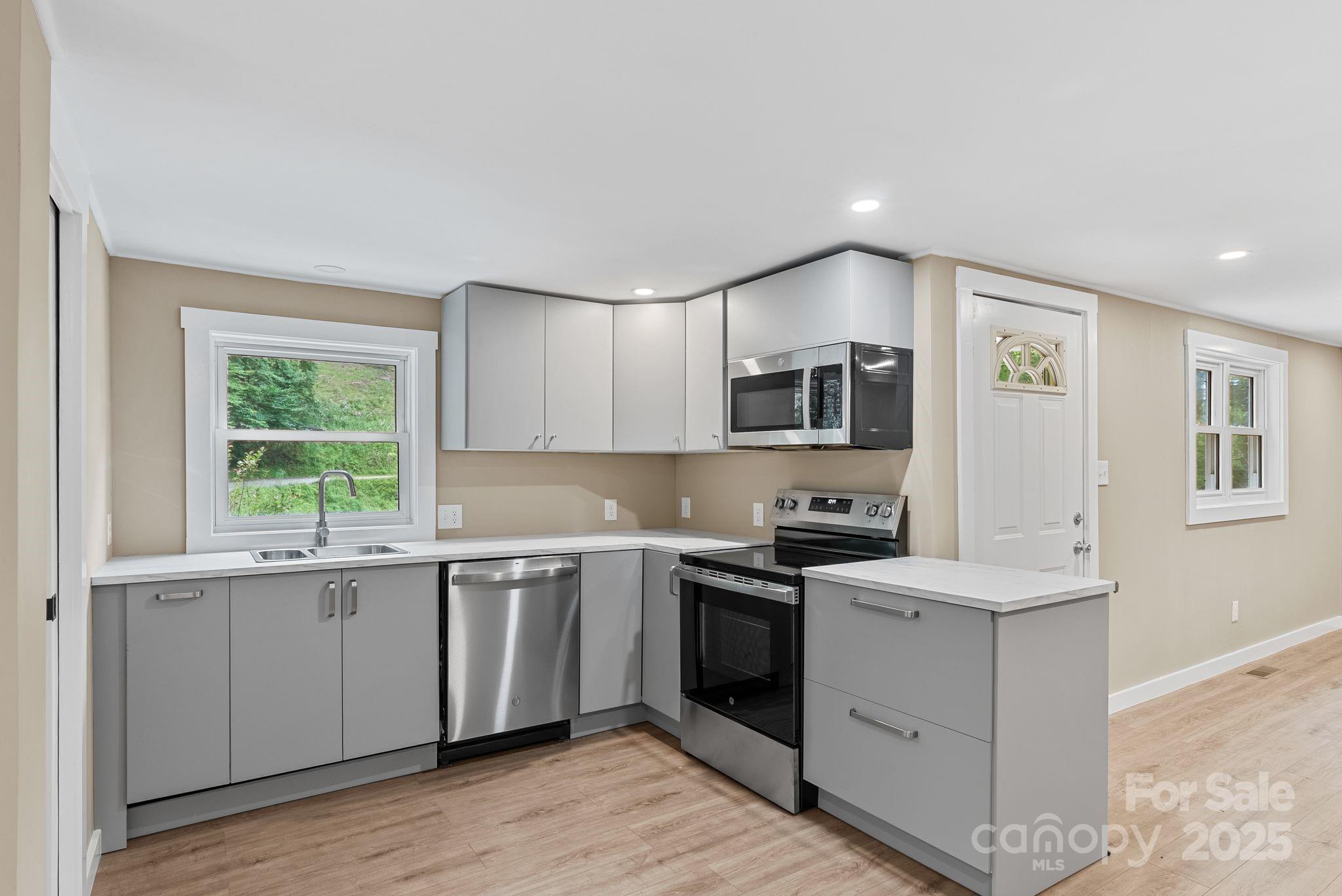 530 Rebel Ridge Road Marshall, NC 28753 - Photo 16 of 46 a kitchen that has a sink and a stove in it