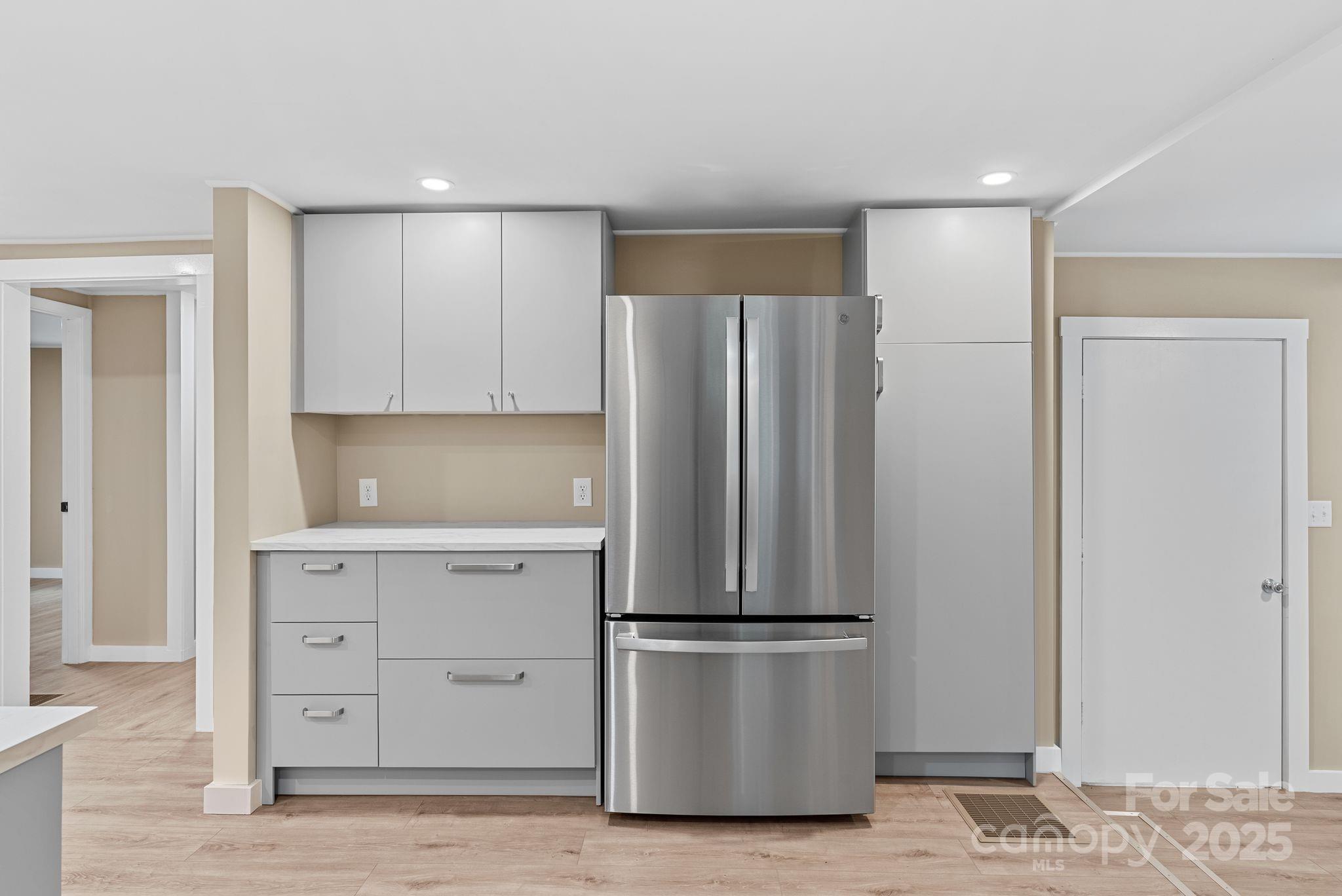530 Rebel Ridge Road Marshall, NC 28753 - Photo 17 of 46 a kitchen with a refrigerator and white cabinets