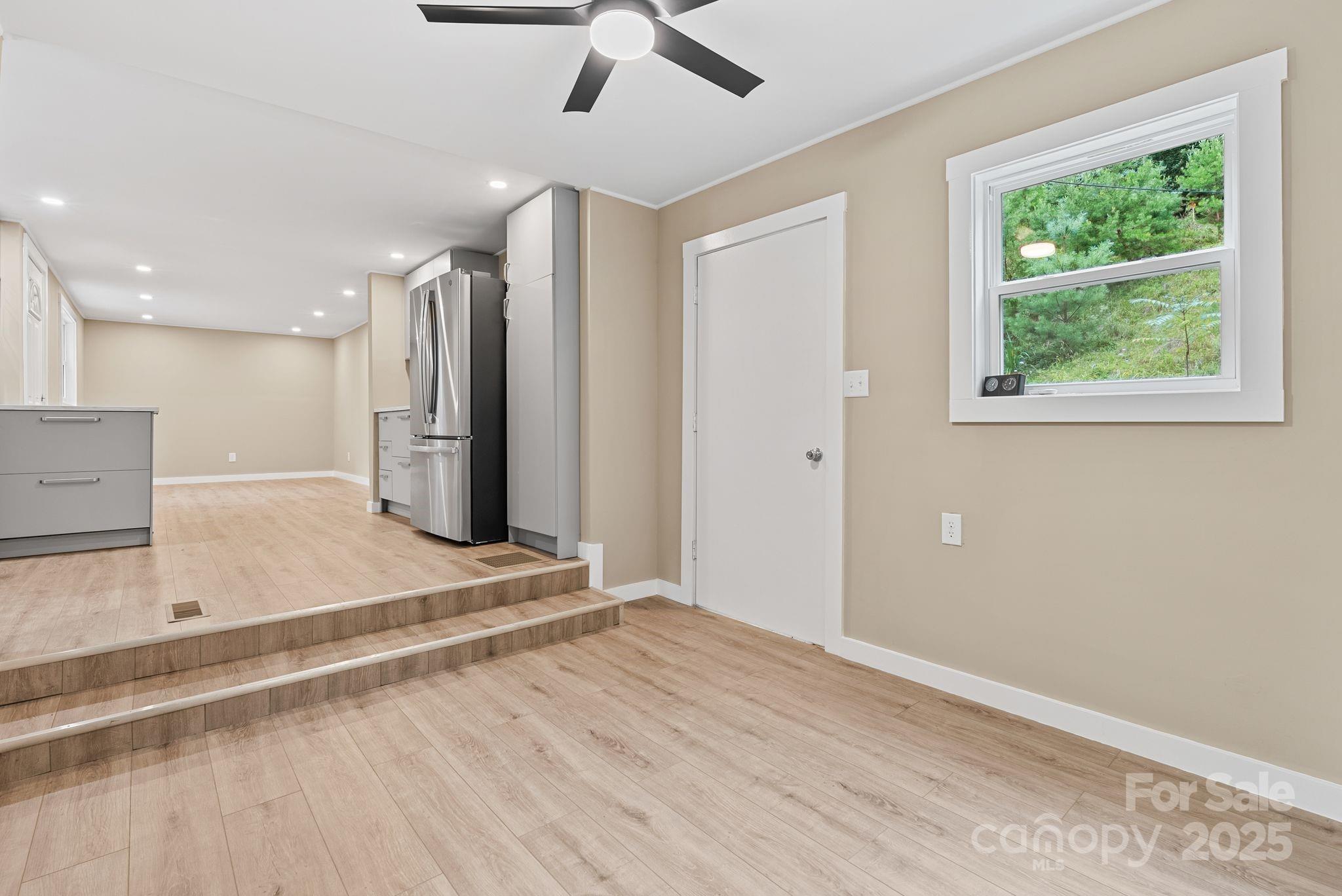 530 Rebel Ridge Road Marshall, NC 28753 - Photo 19 of 46 a view of an empty room with a window