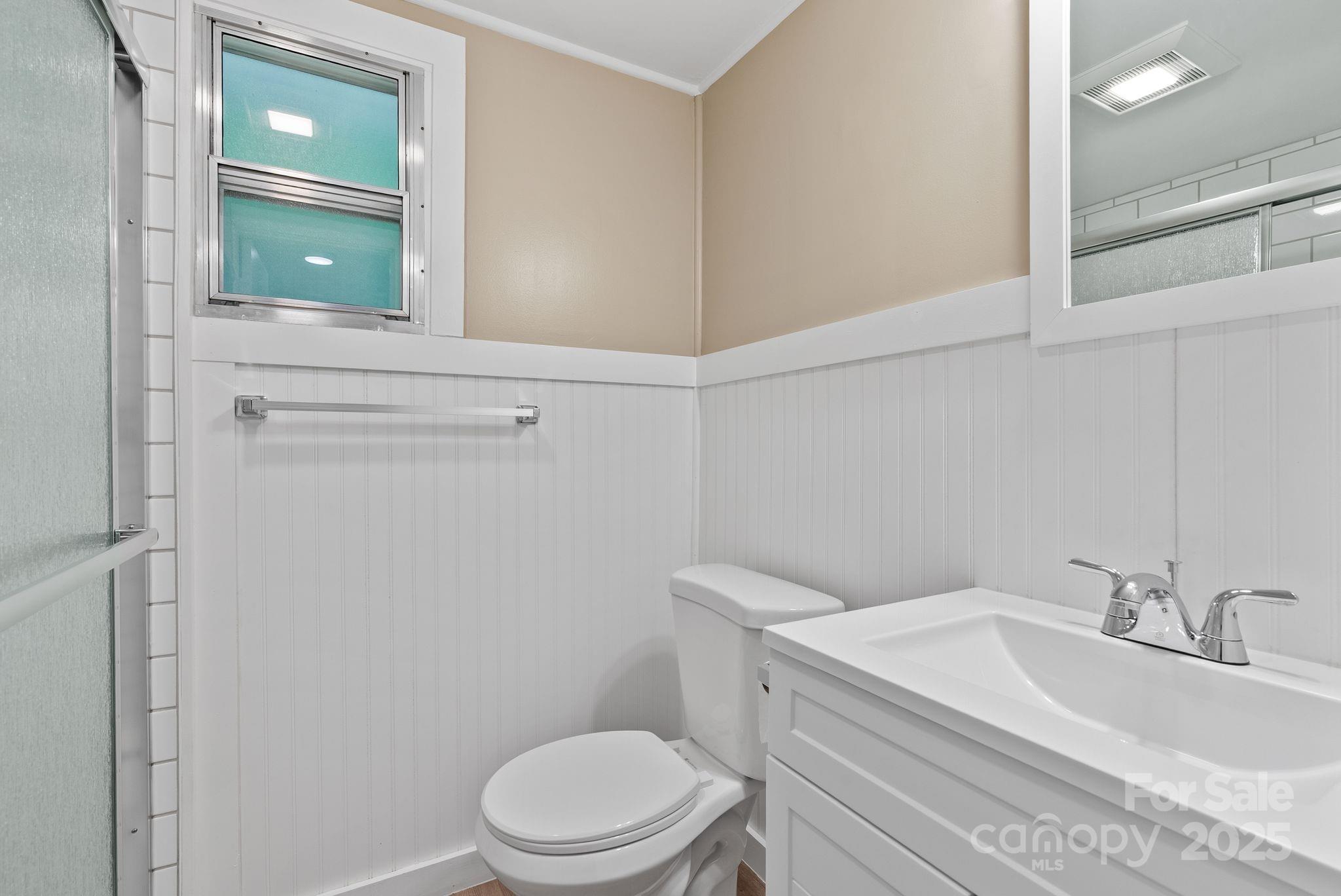 530 Rebel Ridge Road Marshall, NC 28753 - Photo 26 of 46 a bathroom with a sink a toilet and mirror