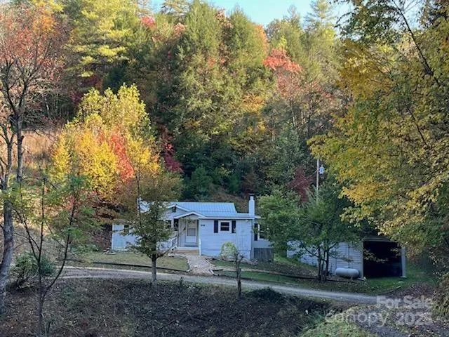 a front view of a house with a yard and tree s