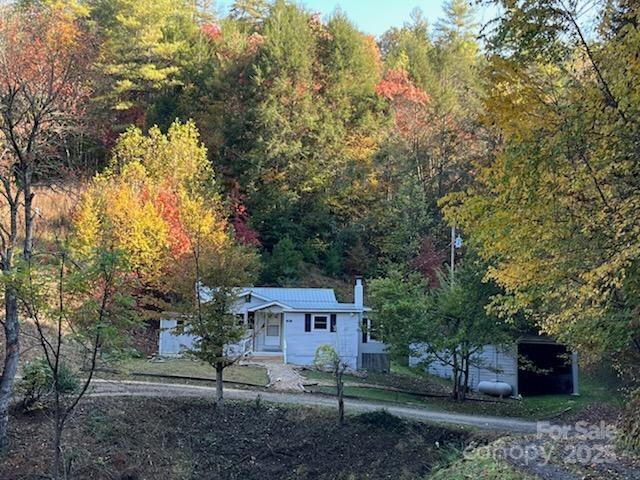 530 Rebel Ridge Road Marshall, NC 28753 - Photo 4 of 46 a front view of a house with a yard and tree s