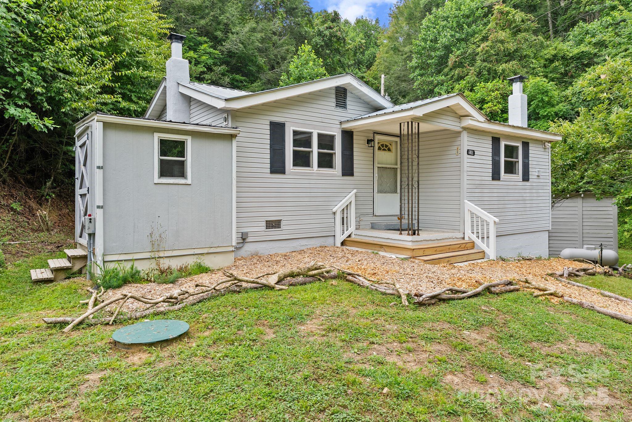 530 Rebel Ridge Road Marshall, NC 28753 - Photo 10 of 46 a front view of a house with a yard