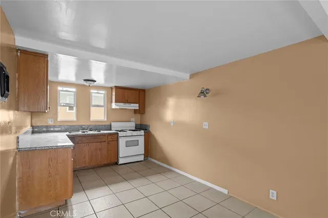 a kitchen with stainless steel appliances granite countertop a sink and a stove top oven