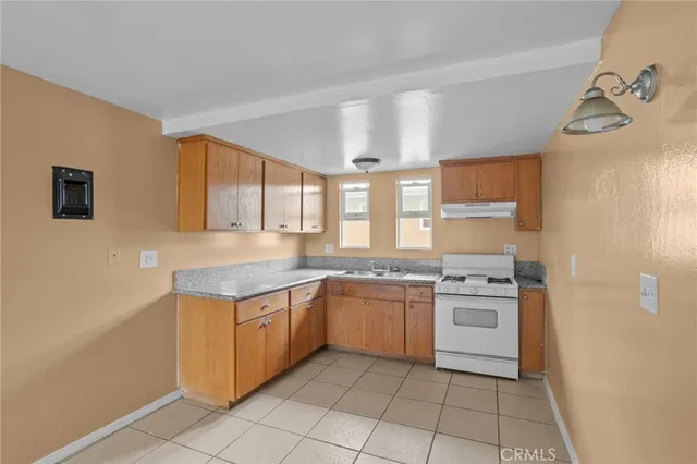 a kitchen with a stove a sink and a refrigerator