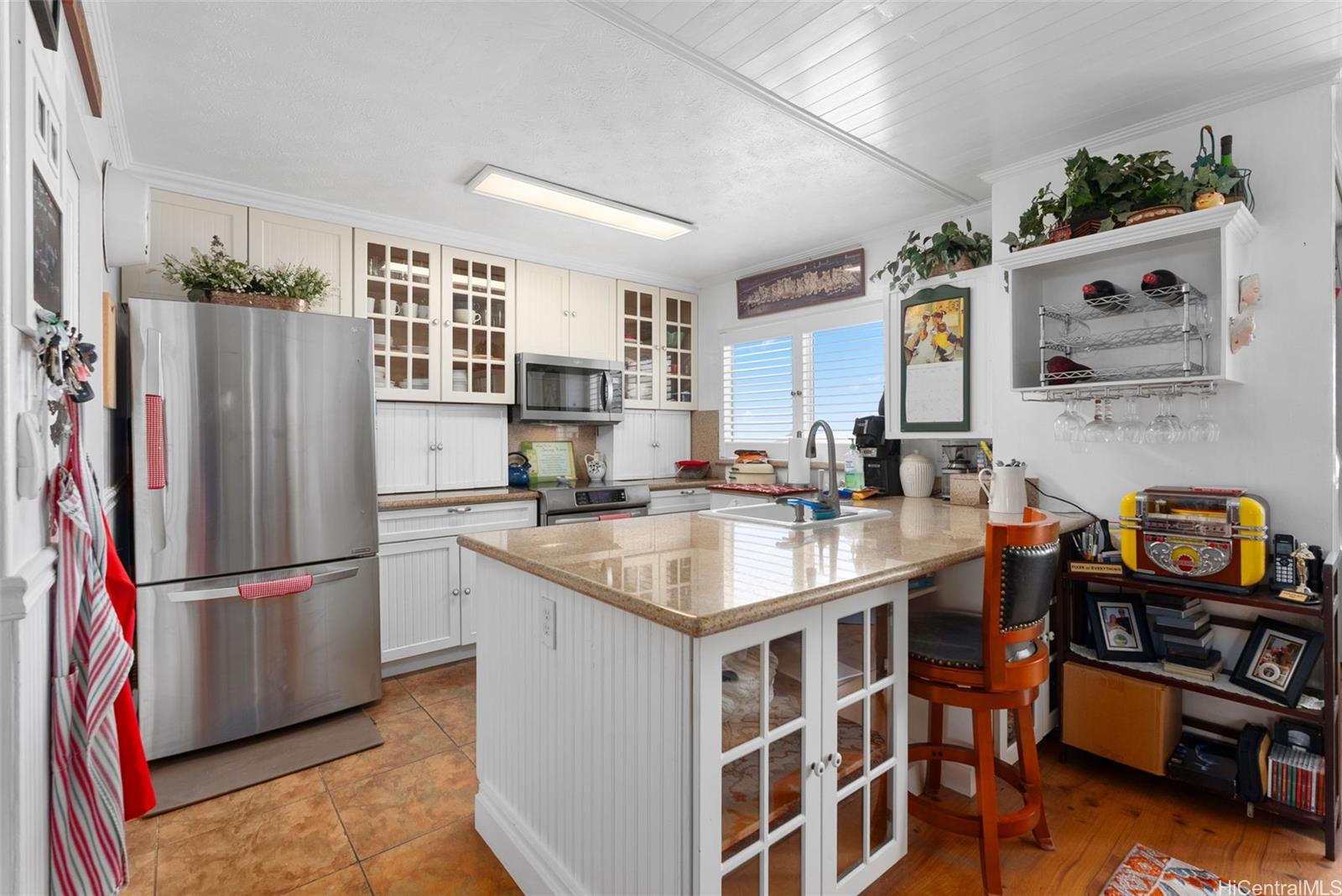 a kitchen with stainless steel appliances granite countertop a refrigerator and a sink