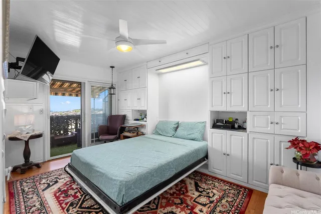 a bed room with a bed and a television