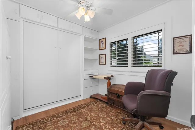 a livingroom with workspace and a window
