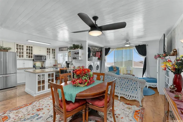 a view of a dining room with furniture and a kitchen