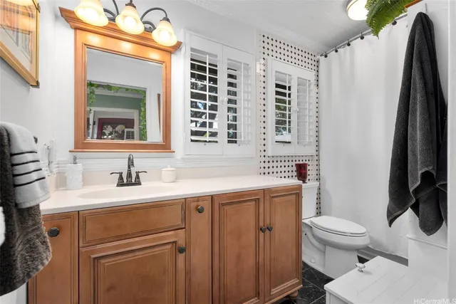 a bathroom with a sink a toilet and a mirror