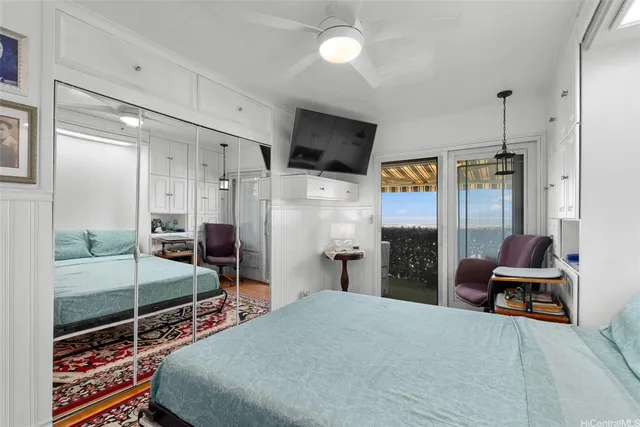 a bedroom with a bed and a flat tv screen