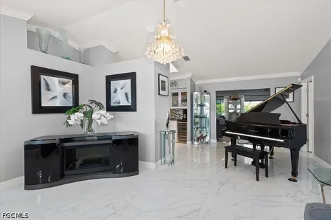 a living room with furniture a piano and a chandelier
