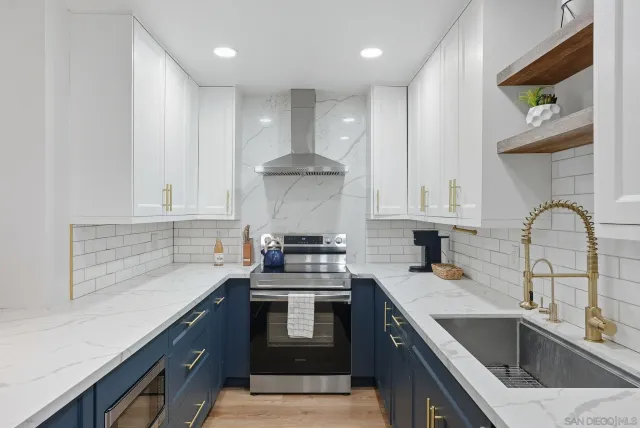 a kitchen with a sink cabinets and stainless steel appliances