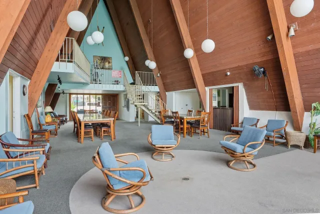 a room with lots of chairs and mirrors