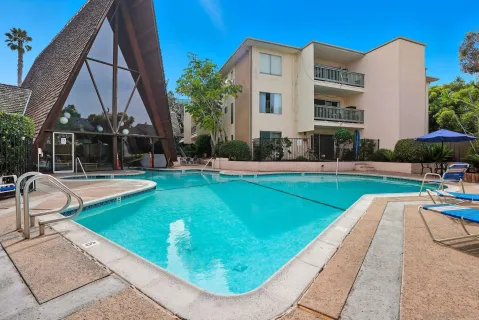 a swimming pool with outdoor seating and yard