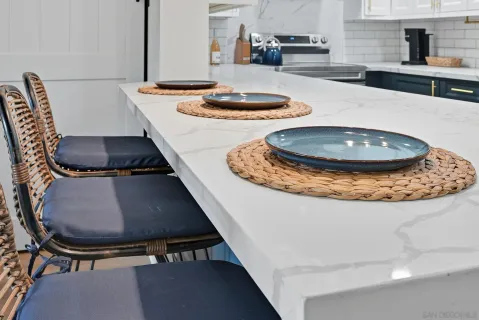 a view of a kitchen with kitchen island stainless steel appliances a sink and a stove